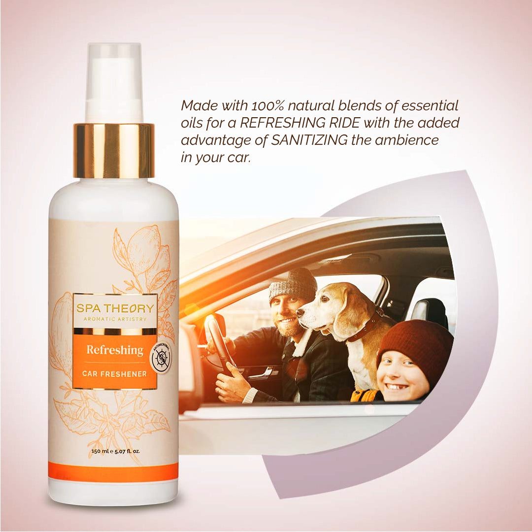 Bottle of "Refreshing" car freshener with orange and floral design on a light gradient background