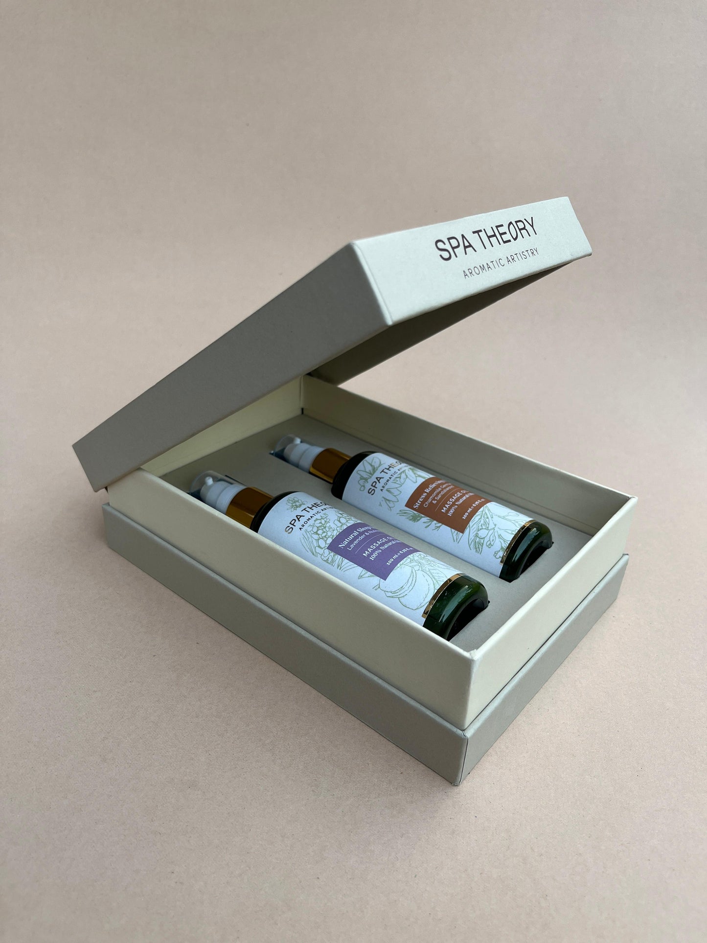 A beige box labeled "Spa Theory: Aromatic Artistry" contains two bottles